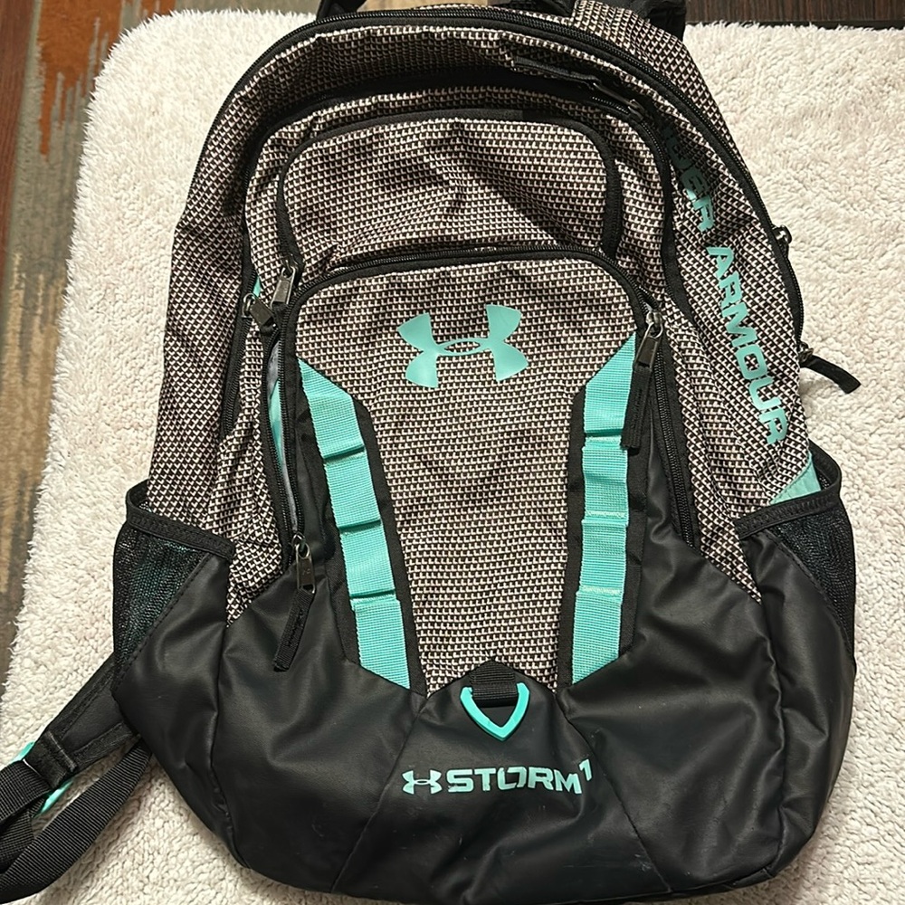 Under Armour Storm 1 backpack with 4 outer zipper and 2 side mesh pockets.